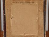 painting on an easel with a piece of cardboard on it