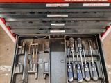 many tools in a tool box on the floor