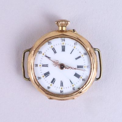 a gold pocket watch with roman numerals on the face