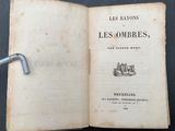 an open book with a metal handle sitting on top of a table