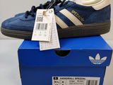 a pair of blue and white sneakers sitting on top of a blue box