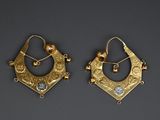 pair of gold earrings with blue stones and pearls