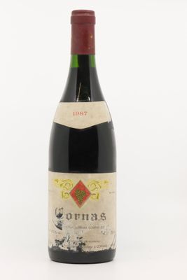 une vieille bouteille de vin posée sur une surface blanche