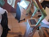 a room with a bed and a computer on a stand