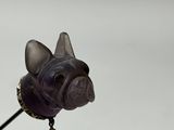 a figurine of a dog with a collar on it ' s head