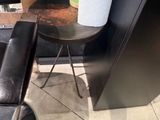 a chair and a table with a vase of flowers on it