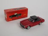 a red toy car sitting next to a red box