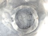 a close up view of a metal bowl with a hole in it