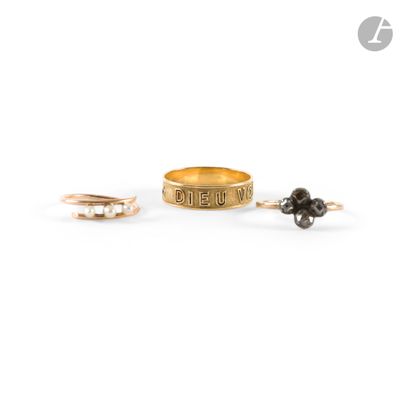 a close up of two gold rings with black stones on them