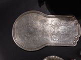 a silver tray sitting on a table with spoons and spoons