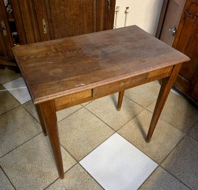 a wooden table with a drawer underneath it on a tiled floor