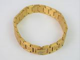 yellow gold plated bracelet on a white surface with a white background