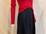 a mannequin wearing a red sweater and black skirt
