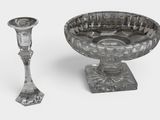 a glass bowl and a glass candle holder on a table