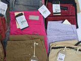 many different colored pants on display in a store