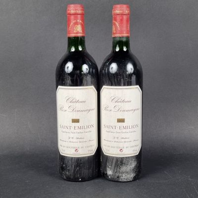 two bottles of wine sitting next to each other on a table
