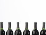 several bottles of wine are lined up in a row on a table