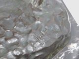 a close up of a statue of a person on a rock