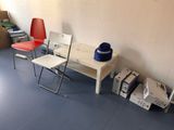 two chairs and a table in a room with boxes on the floor