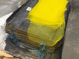 a pile of bags of fabric sitting on a pallet in a warehouse