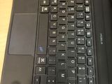 a black laptop computer sitting on a wooden desk