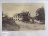 an old photo of a horse drawn carriage in front of a house