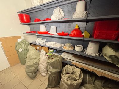 many bags of items on the shelves in the room
