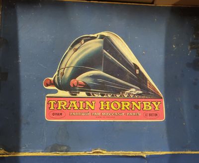 a train sign on the side of a blue wall