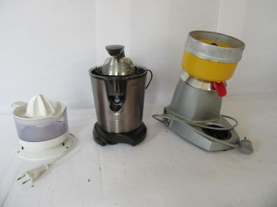 two juicers sitting next to each other on a table