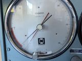 a close up of a clock on the side of a machine