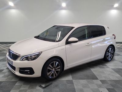 the white car is parked in a large room with checkered floor