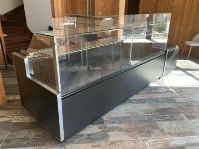 a glass display case in the middle of a room