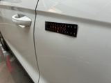 a sticker on the door of a white car