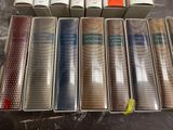 several old books are lined up in a row on a table