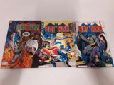 trois bandes dessinées Batman posées sur une surface blanche