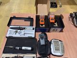 many electronic gadgets laid out on a table