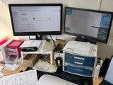 a desk with two computer monitors and a laptop on it