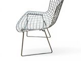 the wire chair is made of metal and has a black seat