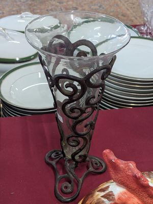 a glass vase sitting on top of a red table cloth