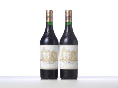 two bottles of wine sitting on top of a table