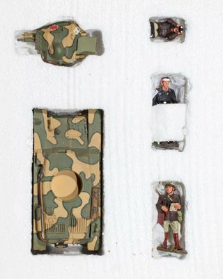 a picture of a toy tank and other items on a white surface