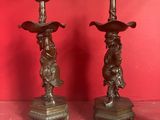 pair of antique bronze candlesticks with cherenshes and cherenshes on them