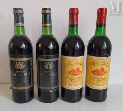four bottles of wine are lined up on a table
