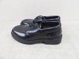 they are black shoes with laces on them on a white surface