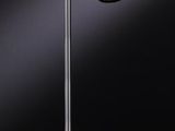 a black lamp on a table with a black background