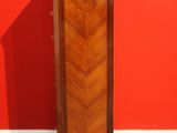 an image of a tall cabinet against a red wall