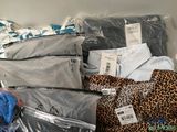 a pile of clothes that is sitting on top of a shelf