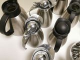 a lot of different types of coffee pots on the table