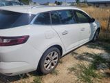 a white car that is parked on the side of the road