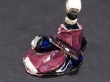 a miniature figurine of a man sitting on a shoe